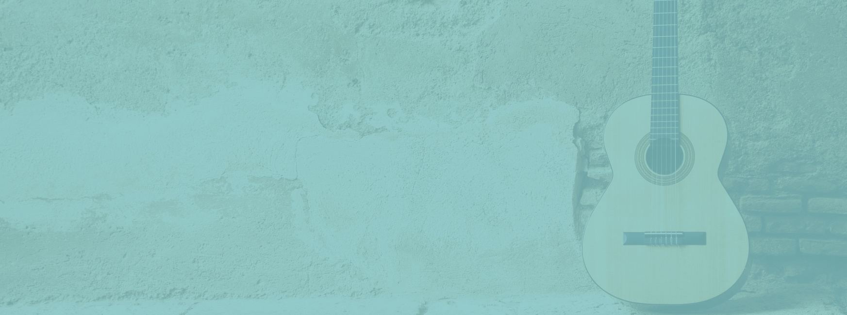 An acoustic guitar leaning against a cement wall with a light teal color overlaid.